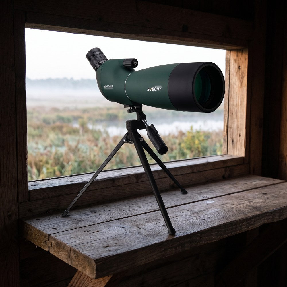 La longue-vue SV28 25-75x70 sur son petit trépied de table, posée sur le rebord d'une fenêtre d'affût qui donne sur un marais dans la brume